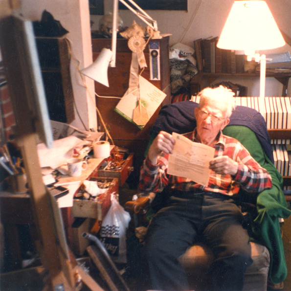 L.V. Hogue reading in his work area.